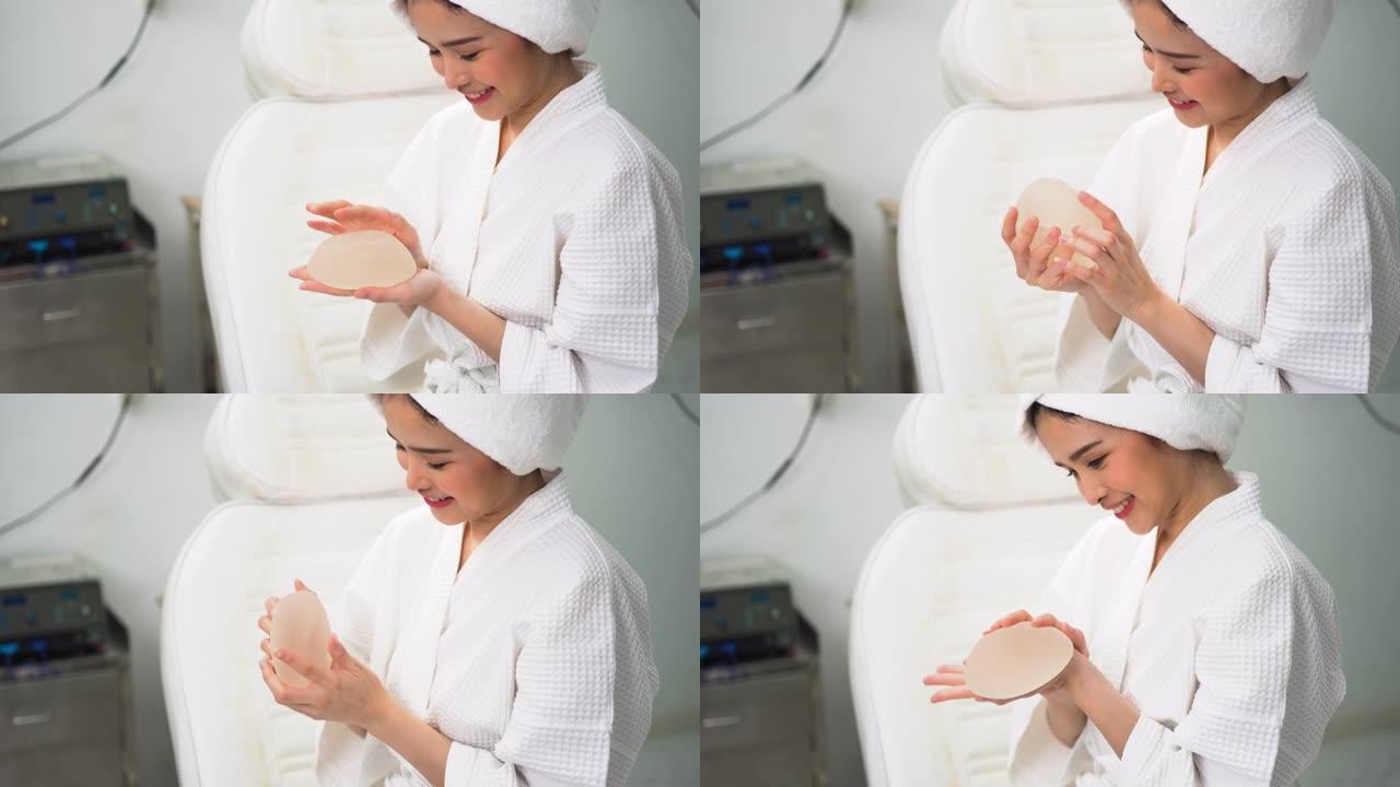 准备用硅胶隆胸的年轻女性患者的手正在美容诊所测试硅胶隆胸。
