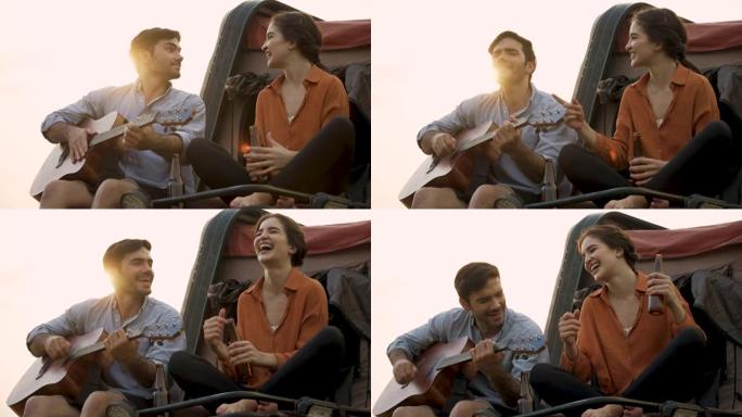 浪漫的情侣在露营时一起弹吉他和唱歌。