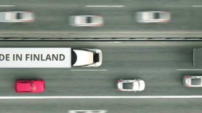 拖车的空中俯视图，芬兰制造文本沿着道路行驶。芬兰商业相关可循环3D动画