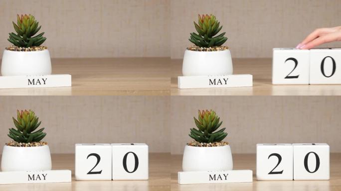 日历上的重要日期或事件是5月20日的。女性手用数字移动立方体。