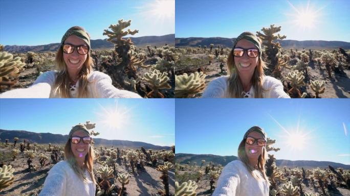 开朗的年轻女子在加利福尼亚的仙人掌花园拍摄自拍照视频