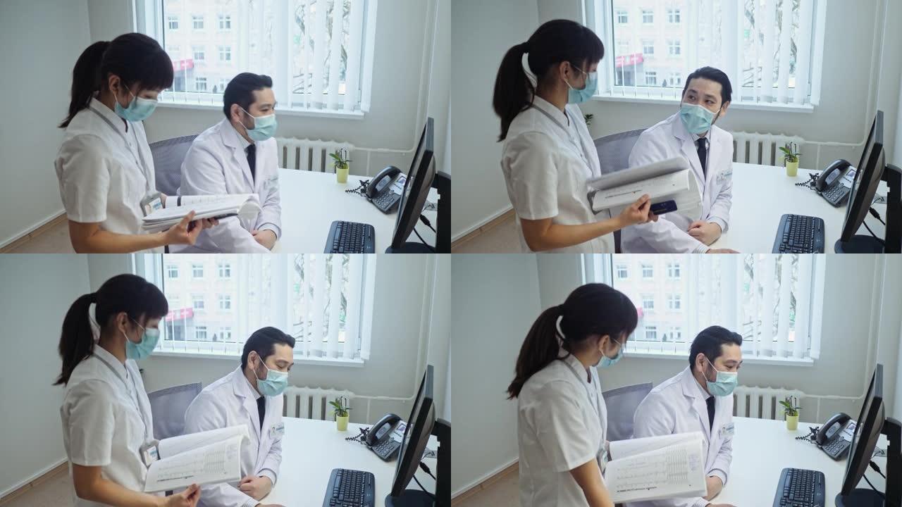 日本女护士和男医生讨论电脑屏幕后工作