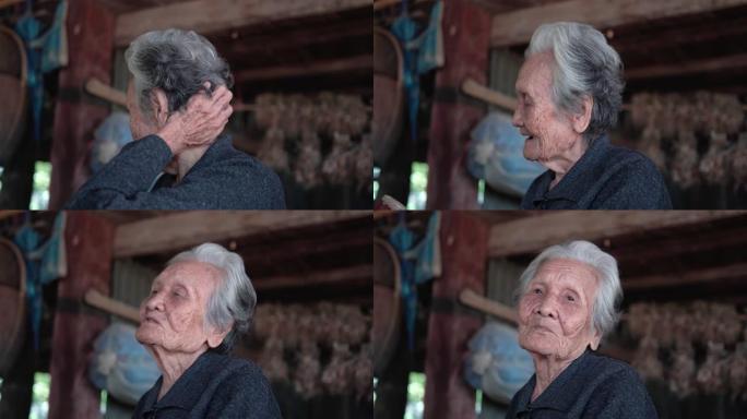 快乐的亚洲高级女性，头和肩膀看一个年长的女性坐在泰国农村的家里聊天，老年女性的概念