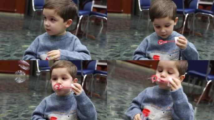 一个孩子坐在地板上，喜欢用玩具制作肥皂泡，并对此感到惊讶的视频