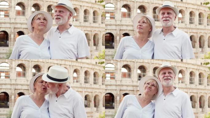 在罗马度假的老年旅行者的家庭。一对老年情侣在意大利罗马斗兽场前接吻