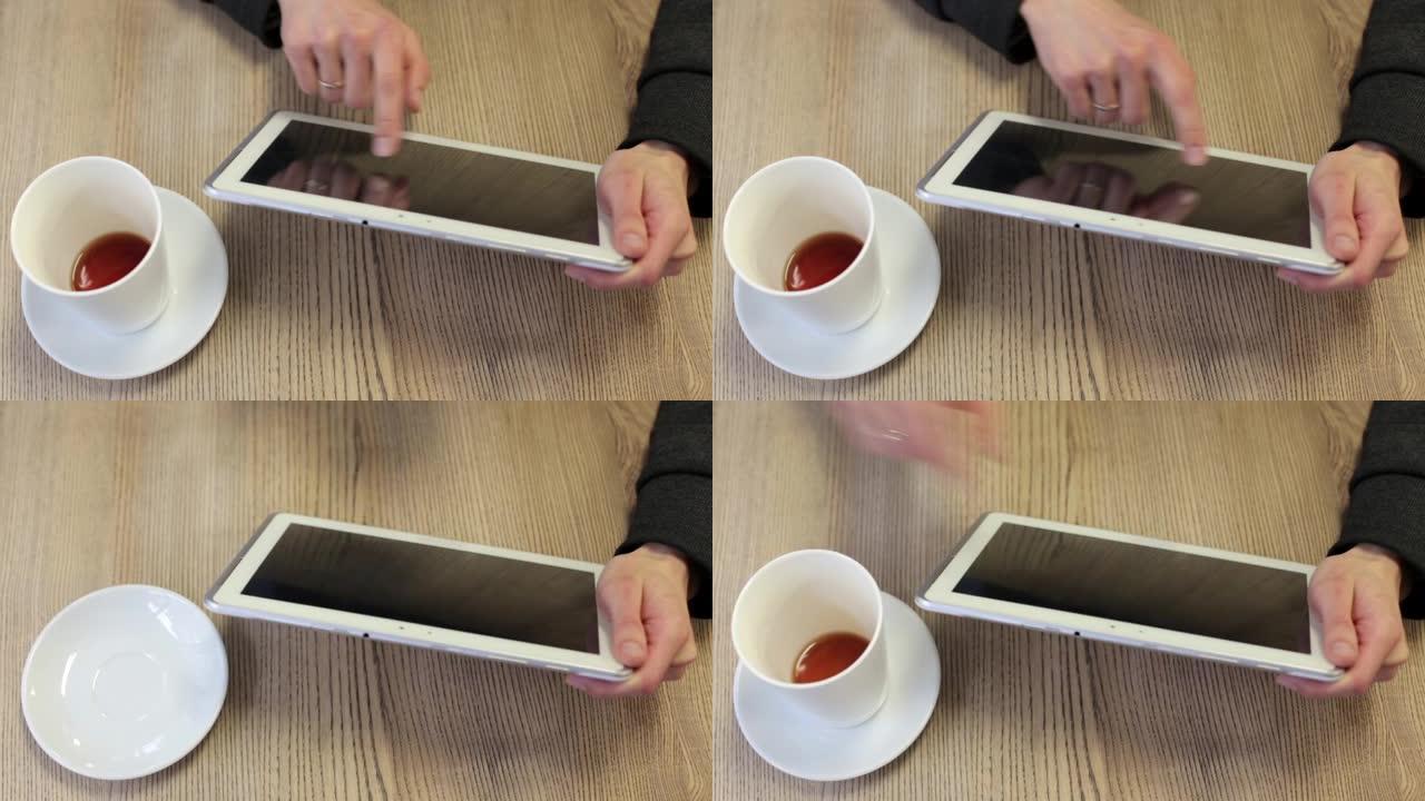 商人在餐厅喝咖啡休息，并在平板电脑上运行