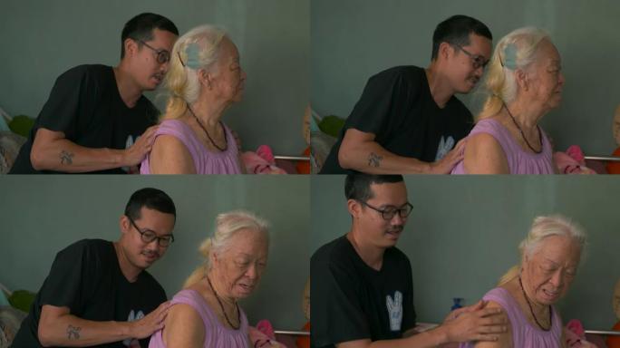 亚洲孙子在家床上给奶奶按摩。