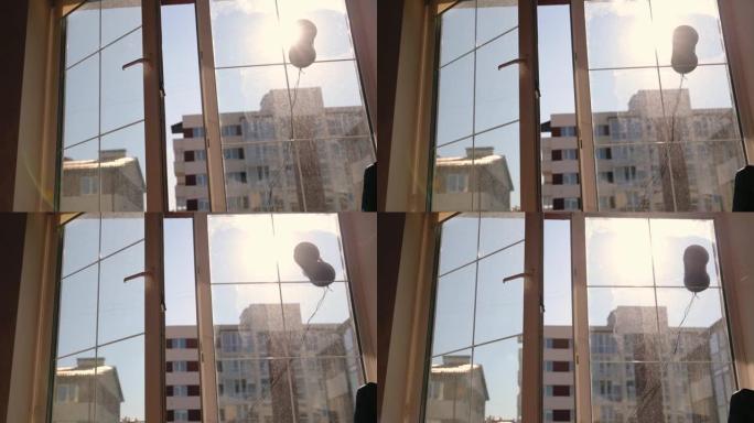 洗窗户的机器人。早晨的阳光照进房间。清洗窗户的机器人的轮廓
