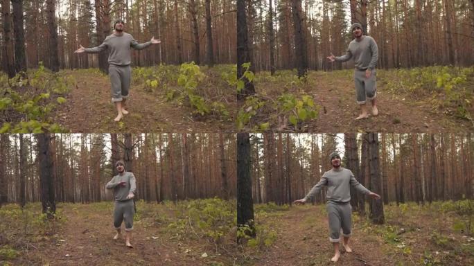 一个赤脚的男人在秋天的森林里唱歌说唱，握着手，看着相机。加速视频