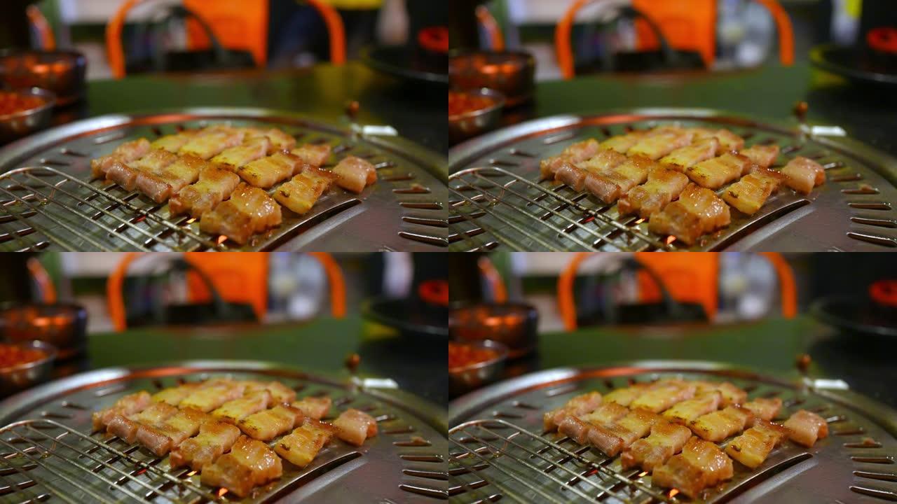 韩国铁烧烤烤盘上的4k厨师手工烧烤猪肚肉