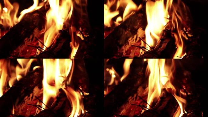 篝火燃烧柴火在夜间户外露营，背景模糊，焦点灵敏。