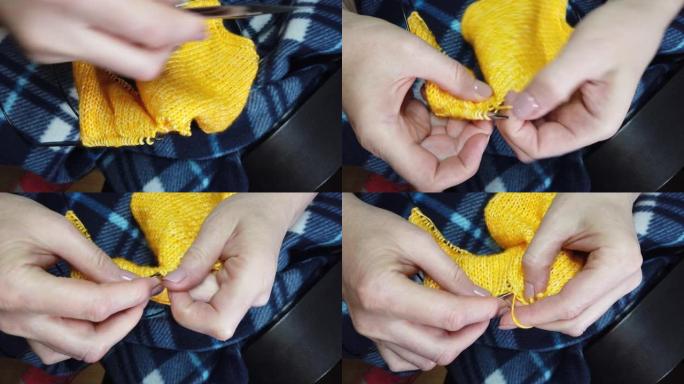 女式手工针织羊毛夹克，配有织针。俯视图，手和编织的特写。