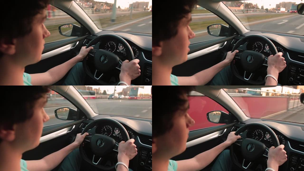 男性驾驶汽车，用手握方向盘。合规速度限制。