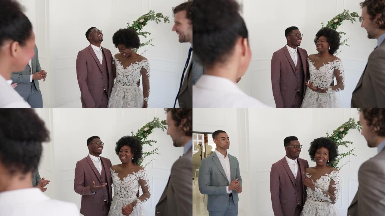 年轻的非洲新婚夫妇与他们的朋友交谈