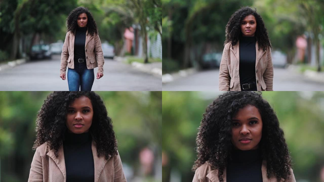 骄傲的黑人女性站在外面。巴西女孩慢动作向前走