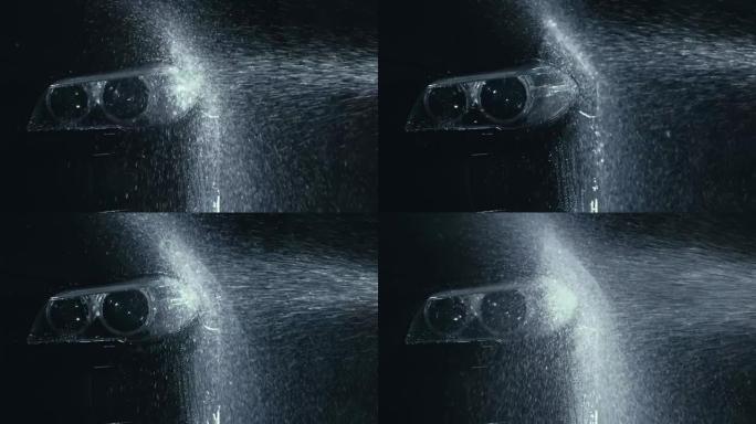 汽车前照灯清洗。用高压喷射清洗软管水清洗现代车身。汽车玻璃前照灯，滴眼液中的天使眼睛。