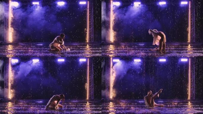 当代舞蹈芭蕾舞演员在水面的雨中性感地跳舞，产生飞溅。穿着白色衬衫的湿女人的轮廓在蓝色灯光下的黑暗工作