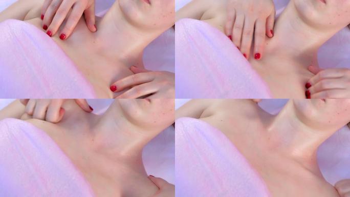 美容师的手在女人的脖子和乳房上做肌瘤按摩。