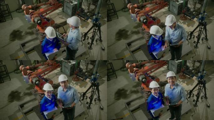穿着安全制服的亚洲emgineer男女技术员的肖像站着转身看着相机，在机械厂工作场所背景下欢快自信地