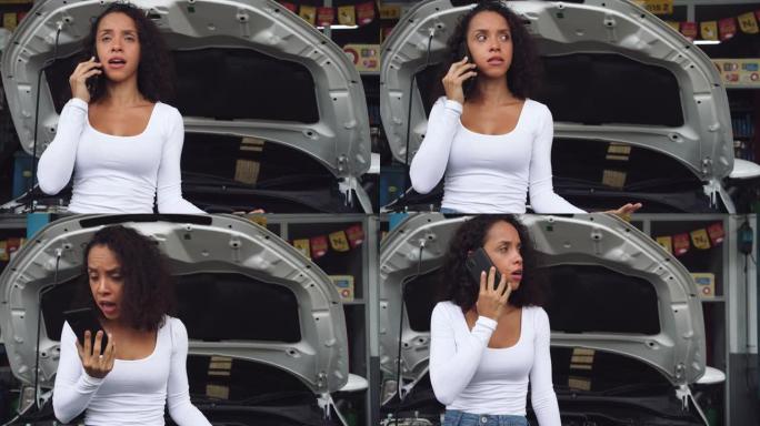 在汽车维修店里，年轻的女人愤怒地用手机说话。