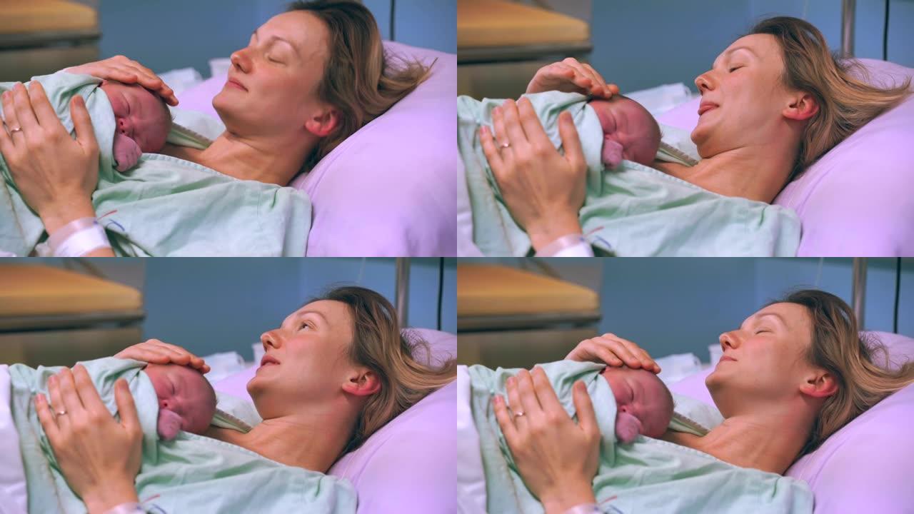 母亲和新生儿。在妇产医院分娩。分娩后，年轻的妈妈拥抱着她刚出生的婴儿。分娩的女人。