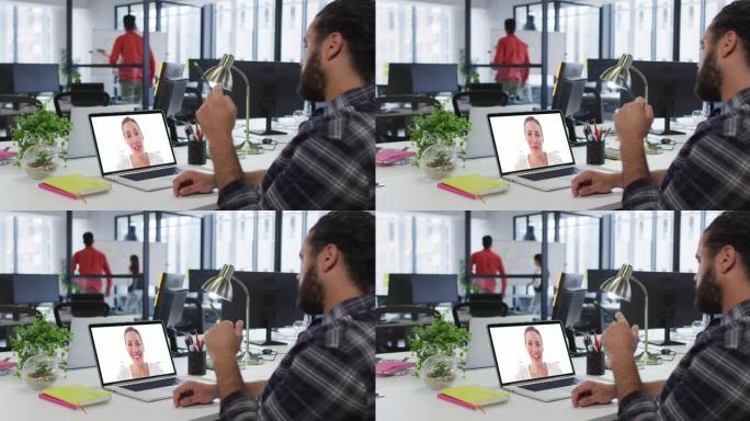 中东男子在办公室的笔记本电脑上与女同事进行视频通话
