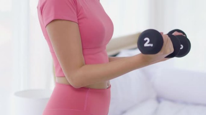 身体特写亚洲女性二头肌热身锻炼重量训练