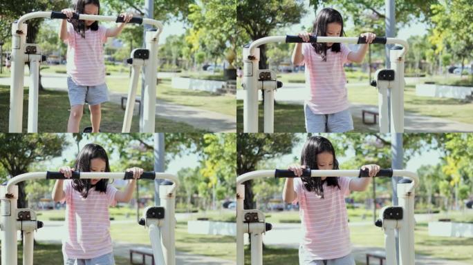 快乐的亚洲女孩在公园户外玩运动器材，积极的生活方式理念。