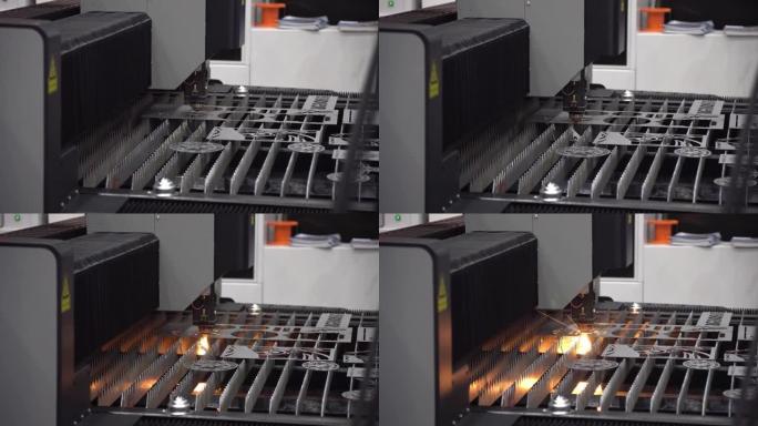 光纤激光切割机的操作用闪闪发光的光切割金属板。