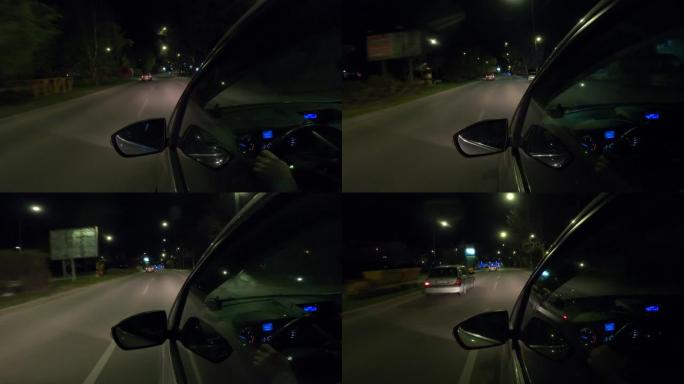 一名男子晚上开着汽车在城市里转转，车窗里倒映着城市照明。