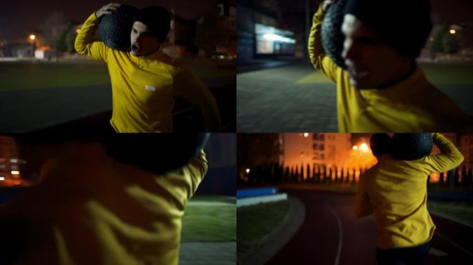 一名运动员晚上在户外用药球跑步