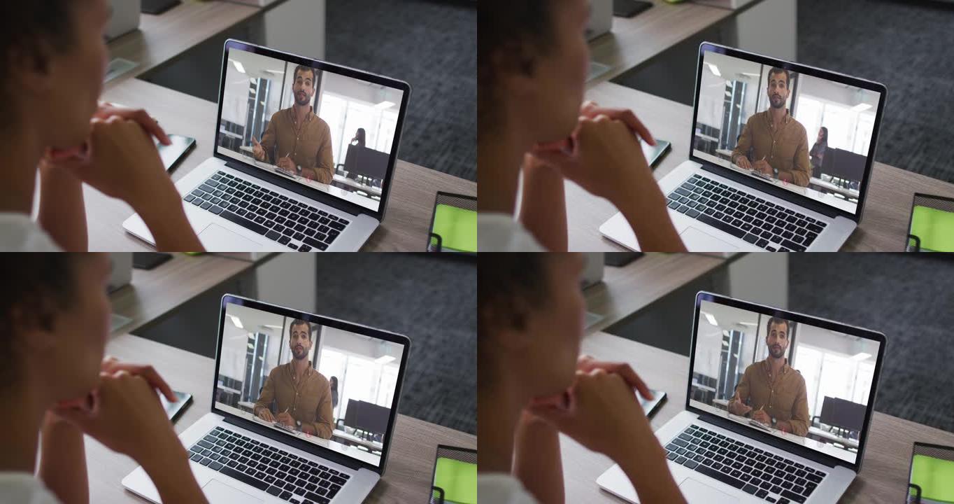 非裔美国妇女在办公室与男同事在笔记本电脑上进行视频通话