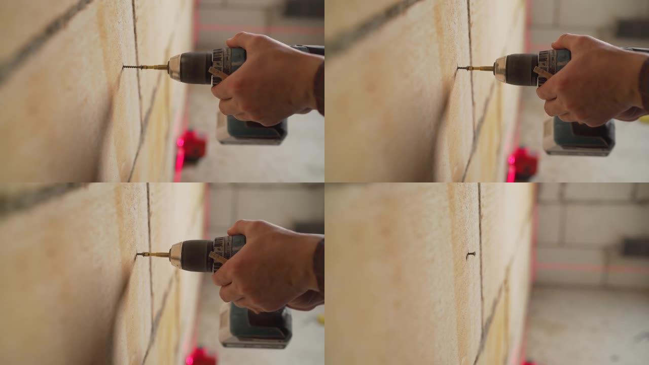 安装金属信标。墙面维修。翻新概念。拧紧墙上的螺丝。工人用钻头拧紧螺丝。