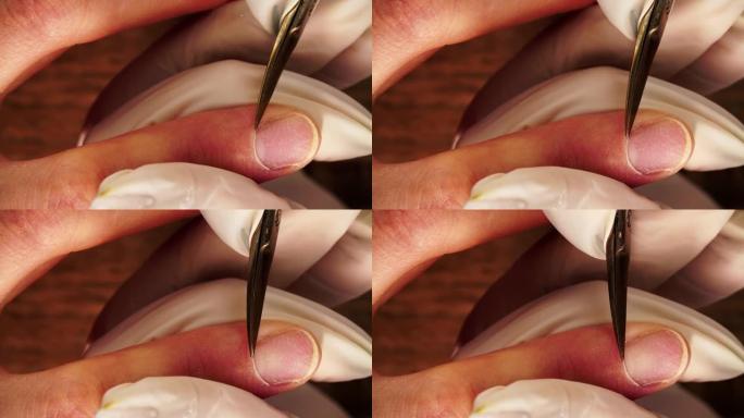美甲师在从上方拍摄宏观的美容指甲过程中，用金属剪刀切割角质层