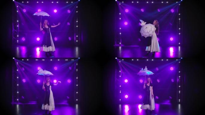 鸟把戏。一名妇女旋转一把花边伞，白色训练有素的鸽子坐在上面，绕着一圈走。专业马戏团表演，在紫色灯光的