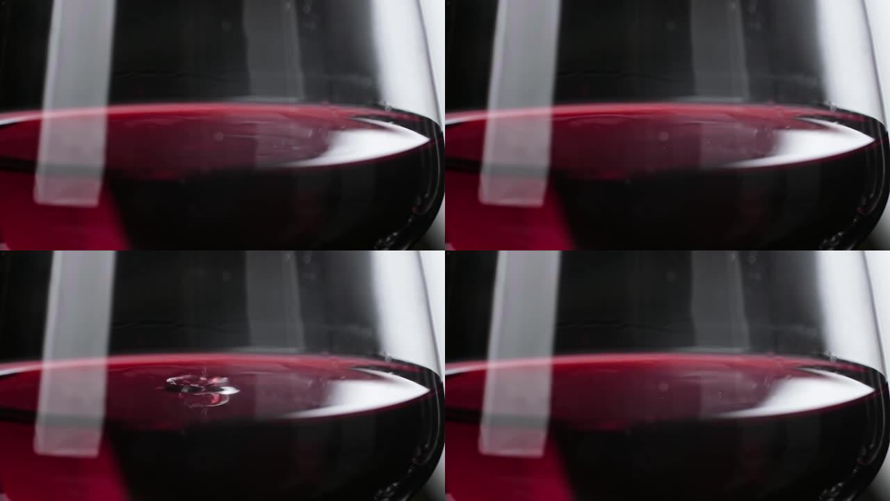 滴落缓慢的玻璃。葡萄酒掉落成红酒的特写镜头