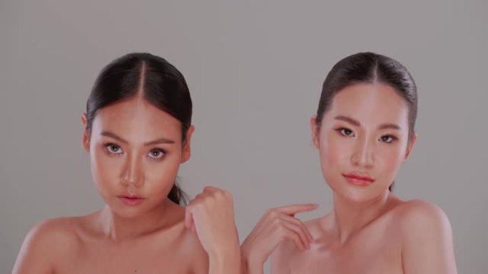 两个亚洲年轻女性的美丽面孔，皮肤自然。一对皮肤白皙、皮肤黝黑的漂亮女孩。