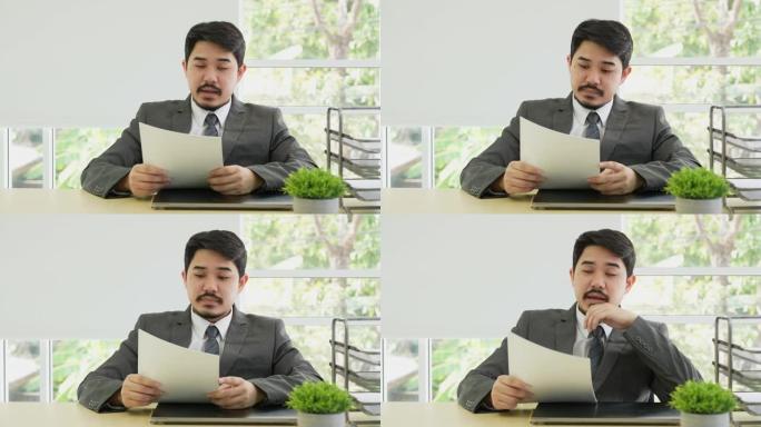 慢动作经理商人阅读候选人的详细信息并开始面试，以询问个人资料，毕业，工作经验和私人办公室的生活目标，