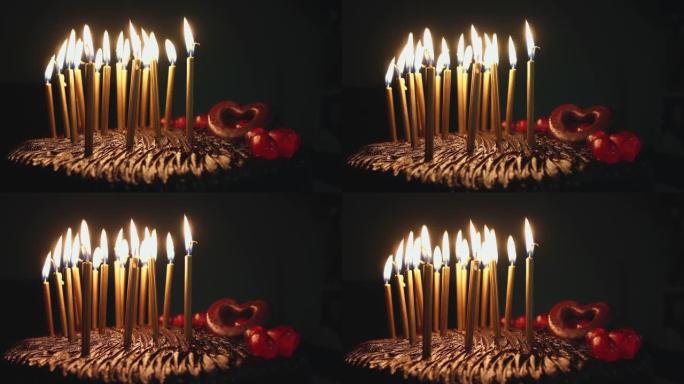 生日快乐巧克力蛋糕配五颜六色的金色蜡烛发光
