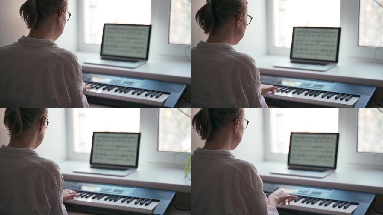 一名年轻女子在钢琴键盘上弹奏的背景