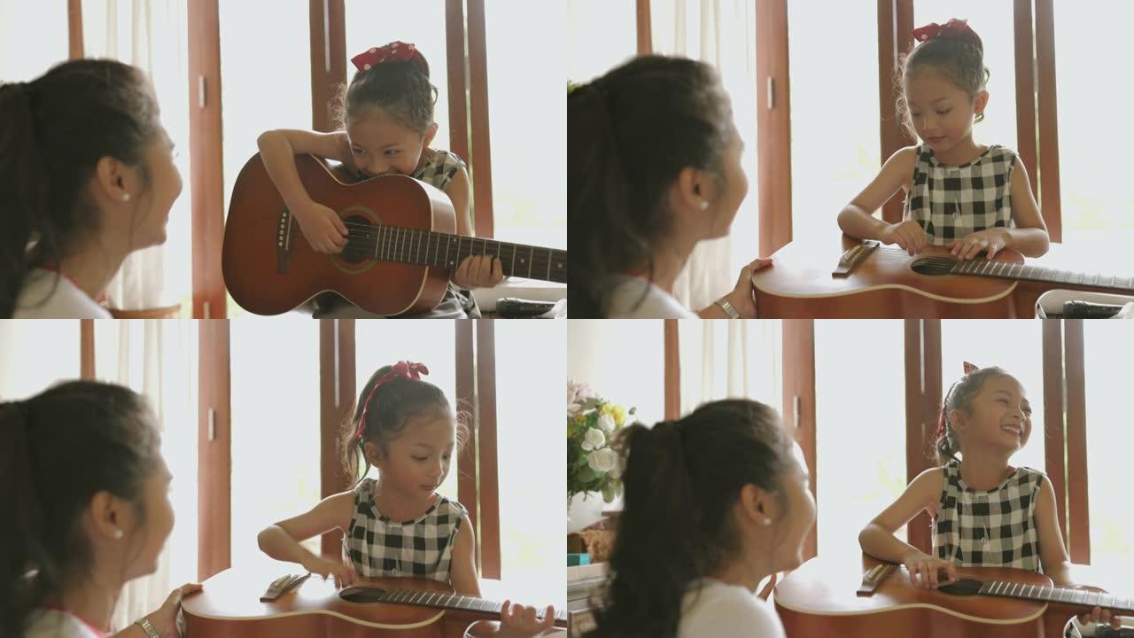可爱的小女孩在姐姐身边第一次尝试弹吉他时唱歌-股票视频