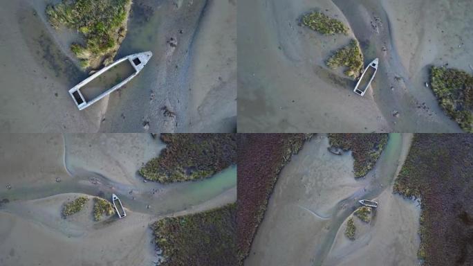 在受污染的沙地上，灌木打破了摩托艇船体