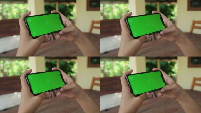 女人使用绿屏观看智能手机