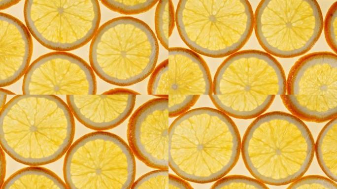 橙色背景上的新鲜橙片慢动作。橙色水果图案。健康食品背景。微距拍摄