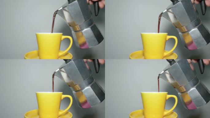 将咖啡倒入意式咖啡杯。咖啡moka maker，咖啡因成瘾，早晨早餐