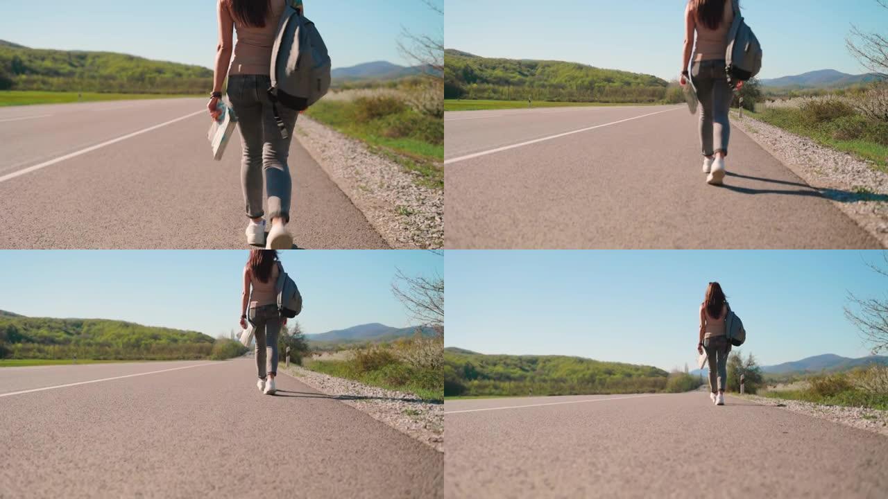 一个背着背包的女人沿着马路走。后视图。放下相机。搭便车旅行的概念