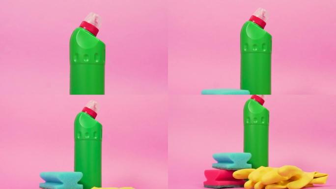 一瓶绿色的塑料洁面乳，两个海绵和橙色乳胶手套。