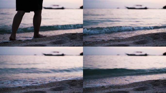 夏季日落时赤脚独自在沙滩上行走的特写，女性的脚踩在海上