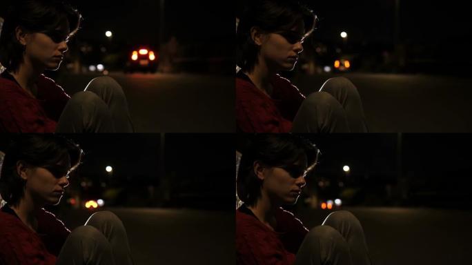 孤独，沮丧的女孩坐在人行道上想着她的前男友