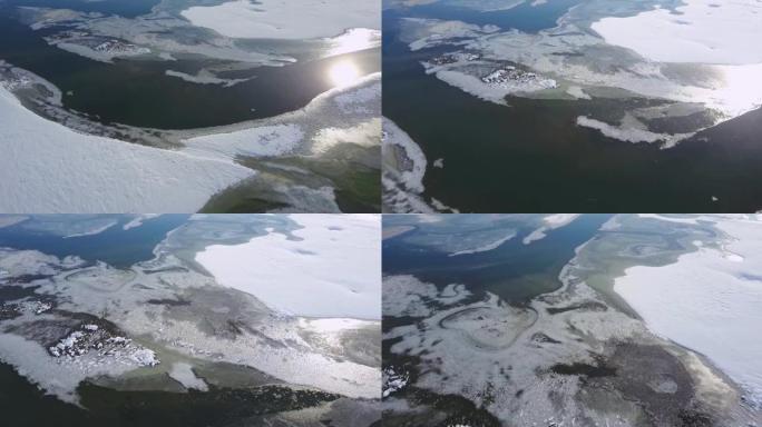 春季冰漂在冰冻的冬季河湖鸟飞越-无人机收藏股票视频